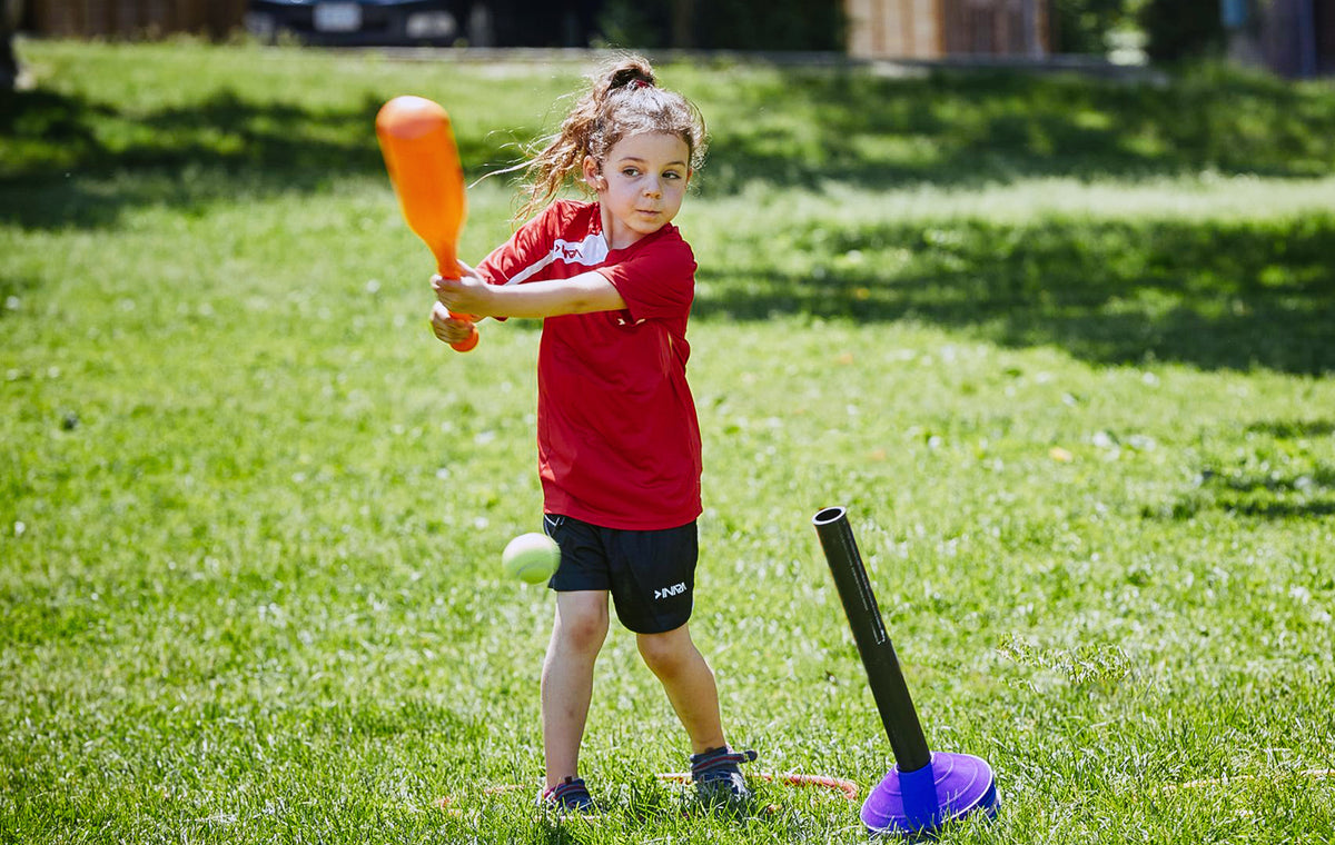 Sports programs, girl playing t-ball