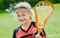 Sports coaching, girl playing lacrosse