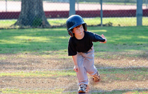 Boy playing T-ball